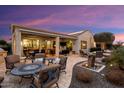 Covered patio with seating area and outdoor dining space at 27062 W Behrend Dr, Buckeye, AZ 85396