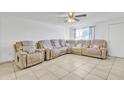 Spacious living room with tile floors and a large sectional sofa at 3144 N 81St Dr, Phoenix, AZ 85033