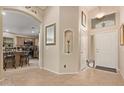 Bright entryway with tile flooring and kitchen view at 37110 W Leonessa Ave, Maricopa, AZ 85138