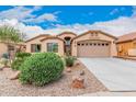 Single-story home with desert landscaping and two-car garage at 37110 W Leonessa Ave, Maricopa, AZ 85138