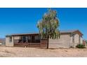 Single story home with covered porch and mature tree in front at 43459 N Terrace View Ave, San Tan Valley, AZ 85140
