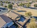 Aerial view showcasing house, backyard patio, and surrounding neighborhood at 44932 W Gavilan Dr, Maricopa, AZ 85139