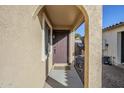 Exterior view of covered entryway with arched doorway and adjacent pathway at 44932 W Gavilan Dr, Maricopa, AZ 85139