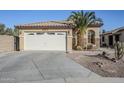 Front view of a single-story house with a two-car garage and desert landscaping at 44932 W Gavilan Dr, Maricopa, AZ 85139
