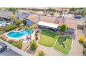 Aerial view showcasing a private backyard with a pool, putting green, and outdoor seating area at 502 E Le Marche Ave, Phoenix, AZ 85022