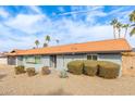 Charming one-story home featuring a desert-landscaped front yard with mature bushes and orange tile roof at 502 E Le Marche Ave, Phoenix, AZ 85022