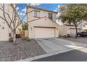 A two-car garage with a concrete driveway in front of a well-maintained home at 5374 W Chisum Trl, Phoenix, AZ 85083