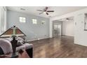 Spacious living room featuring hardwood floors, ample natural light, and a ceiling fan at 5374 W Chisum Trl, Phoenix, AZ 85083