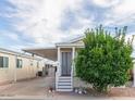 Mobile home exterior with covered porch and landscaping at 8700 E University Dr # 1315, Mesa, AZ 85207