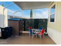 Relaxing covered patio with a garden shed, patio set, and privacy screen, perfect for outdoor living and entertaining at 8700 E University Dr # 1315, Mesa, AZ 85207