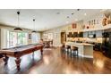 Open concept kitchen boasts a large island with seating, dark cabinetry, and granite countertops at 9441 E Juanita Ave, Mesa, AZ 85209