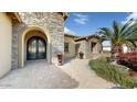 Elegant entryway with ornate double doors and beautiful landscaping at 11454 N 87Th Pl, Scottsdale, AZ 85260