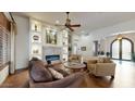Bright living room features a fireplace and comfortable seating at 11454 N 87Th Pl, Scottsdale, AZ 85260
