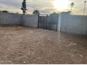 Large backyard with gated entrance and dirt ground at 1508 E Todd E Dr, Tempe, AZ 85283