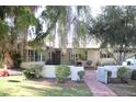 Ranch home with brick pathway, lush lawn, and mature trees at 1526 W Wilshire Dr, Phoenix, AZ 85007