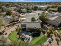 Backyard with putting green, pool, and patio furniture at 15996 W Mesquite Ct, Surprise, AZ 85374