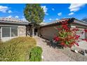 Front entry with red flowers and a walkway to the front door at 15996 W Mesquite Ct, Surprise, AZ 85374