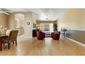 Open concept living and dining area with hardwood floors and ceiling fan at 19504 N 88Th Dr, Peoria, AZ 85382