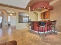 Breakfast bar and kitchen with tile flooring at 22943 W Peakview Rd, Wittmann, AZ 85361