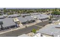 An aerial view captures a desert neighborhood with well-maintained homes, landscaping, and views of the surrounding area at 2929 E Broadway Rd # 44, Mesa, AZ 85204