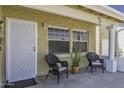 Relaxing front porch with seating and a beautiful front door, offering a welcoming space to enjoy the outdoors at 2929 E Broadway Rd # 44, Mesa, AZ 85204