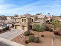 Stunning two-story home featuring a three-car garage, stone accents, and professionally landscaped front yard at 3126 E San Angelo Ave, Gilbert, AZ 85234