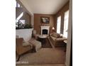 Bright living room with stone fireplace, plush seating, and large windows for ample natural light at 3126 E San Angelo Ave, Gilbert, AZ 85234