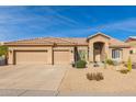 Tan two-story home with a three-car garage and desert landscaping at 4966 E Juana Ct, Cave Creek, AZ 85331