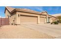Three-car garage with desert landscaping and a wooden fence at 4966 E Juana Ct, Cave Creek, AZ 85331