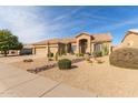 Single-story home with a two-car garage and xeriscaped front yard at 4966 E Juana Ct, Cave Creek, AZ 85331