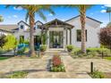 Inviting home entrance featuring a covered porch, manicured landscaping, and a stone pathway at 6235 E Montecito Ave, Scottsdale, AZ 85251