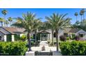 Charming home featuring a grand entrance with mature palm trees and manicured landscaping at 6235 E Montecito Ave, Scottsdale, AZ 85251