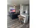 Open kitchen with granite counters, gray cabinets, and a breakfast bar at 625 W Mckellips Rd # 115, Mesa, AZ 85201