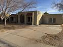 Front view of a single-story house with a large driveway and desert landscaping at 717 W Chilton St, Chandler, AZ 85225