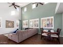 Spacious living room with high ceilings, hardwood floors, and large windows at 739 E Lovebird Ln, Gilbert, AZ 85297