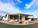 Single-wide manufactured home with covered porch and landscaped yard at 7750 E Broadway Rd # 125, Mesa, AZ 85208