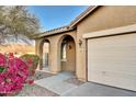 House exterior showing arched entry and attached garage at 7819 S 25Th Ave, Phoenix, AZ 85041