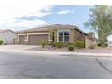 Tan house with a three-car garage and desert landscaping at 809 W Palo Verde Dr, Casa Grande, AZ 85122