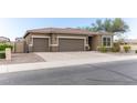 Three-car garage home with desert landscaping and neutral exterior at 809 W Palo Verde Dr, Casa Grande, AZ 85122