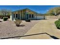 Light yellow single story home with attached garage and desert landscaping at 8500 E Southern Ave # 405, Mesa, AZ 85209