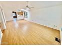 Spacious living room featuring wood-look floors and ceiling fan at 8500 E Southern Ave # 405, Mesa, AZ 85209
