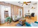 Open living and dining area with exposed brick walls and hardwood floors at 1021 E Roosevelt St, Phoenix, AZ 85006