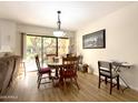 Dining area with wood floors and sliding glass door access to courtyard at 10330 W Thunderbird Blvd # A125, Sun City, AZ 85351
