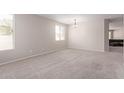 Open living space with neutral walls, carpet, and natural light from the window at 12937 W Highland Ave, Litchfield Park, AZ 85340