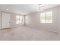Spacious living room featuring neutral walls and plush carpet flooring at 12937 W Highland Ave, Litchfield Park, AZ 85340