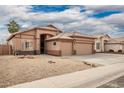 Tan two-story house with a two-car garage and desert landscaping at 15825 W Durango St, Goodyear, AZ 85338