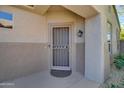 Front door with security screen and decorative accents at 16167 W Quail Creek Ln, Surprise, AZ 85374