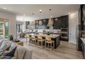 Modern kitchen with dark cabinetry and quartz countertops at 33580 N Maverick Mountain Trl, San Tan Valley, AZ 85144