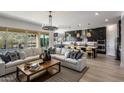 Open living space with modern sectional sofa and kitchen views at 33580 N Maverick Mountain Trl, San Tan Valley, AZ 85144
