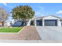 Front view of a single-story house with a two-car garage and landscaped yard at 3728 E Mia Ln, Gilbert, AZ 85298